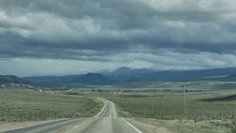 Drive Plate-POV-View forward-Two-Lane Road to Low Hills Cloudy Sky Stock Footage 76622894