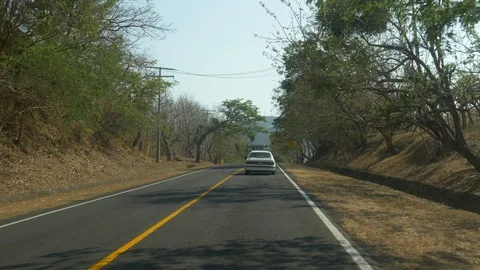 Drive Plate-Tree lined two lane country road-Nicaragua-POV Forward 스톡 동영상 107714046
