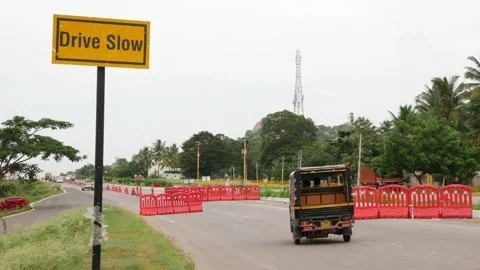 Drive slow traffic control sign at side of road Stock-Footage 156990435