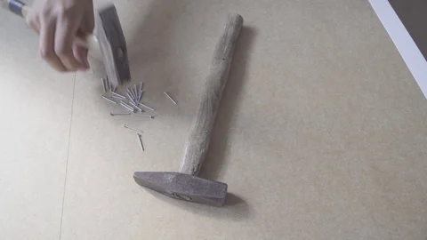 Drive in small nails during cabinet assembly Stock Footage 94180365