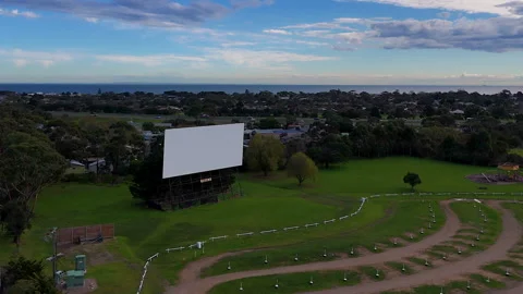 Drive-In Theater Screen Overlooking Coastal Town and Ocean Vídeo Stock 336662915