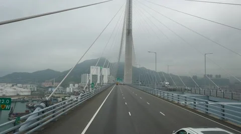 Drive through futuristic cable-stayed bridge, hypnotize hawser lines Stock Footage 56034172