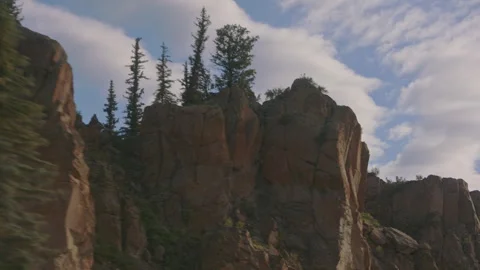 Drive through scenic cliffs and trees showcasing nature's beauty and tranquility Stock Footage 288575519