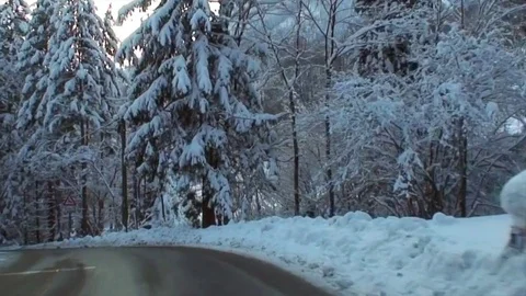 Drive through snowy winding alpine road in high speed II Stock-Footage 84048312