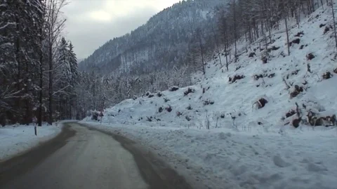 Drive through snowy winding alpine road in high speed III Stockbeeldmateriaal 84048318