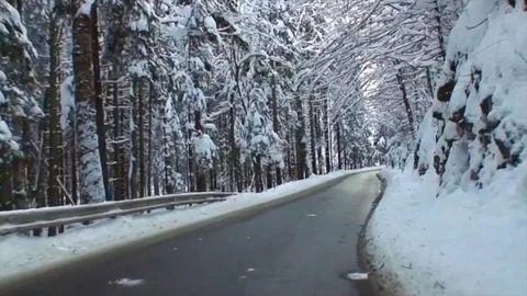 Drive through snowy winding alpine road in high speed VI Stockbeeldmateriaal 84048321