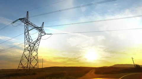Drive toward Sunset with Power Lines and High-voltage tower Pylon Stock Footage 67927763