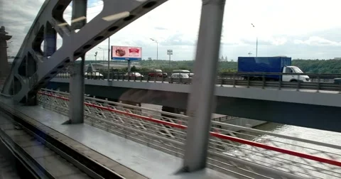 The drive train on the bridge, the view from the train window on the city Stock Footage 67468037