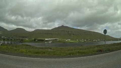 Drive-by view of Sundini strait, bridge over Streymin, and Oyrarbakki village Stock-Footage 339794132