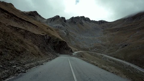 Drive on a winding road of a mountain pass on winter Stock Footage 81865593