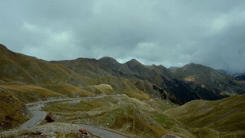Drive on winding road of a mountain pass side view tracking Stock-Footage 81884205