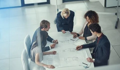 Driven by executive design. a team of corporate architects collaborating on a Stock Photos