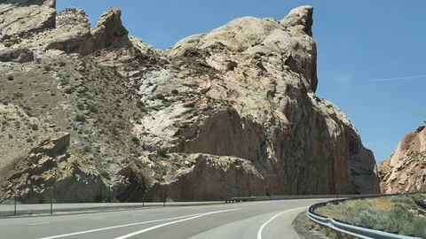 DrivePlate-Driving Interstate-70 Through Rugged Cliffs of San Rafael Swell Utah Stock Footage 77246476