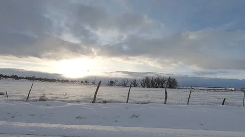 DrivePlate-POV-Side view passing rolling snow covered hills turning corner Stock Footage 103234727