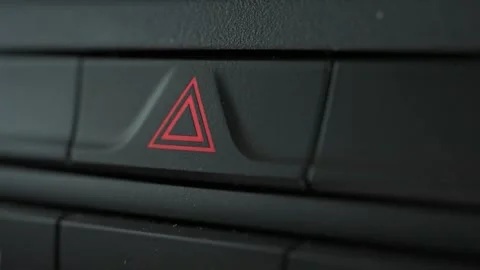 Driver activate emergency light button in the car. Driver finger press Emer.. Stock Footage 293845173