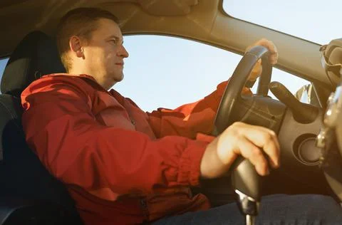 The driver activates the drive option in the automatic transmission. Stock Photos