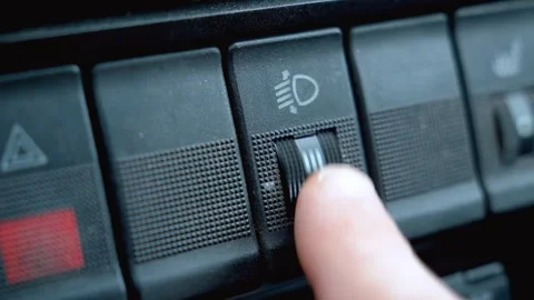 Driver adjusting car headlight level control switch Vídeo Stock 330081375