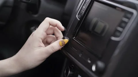 The driver adjusting the volume of a radio inside a car. Action. Close up of a Stock Footage 149597501