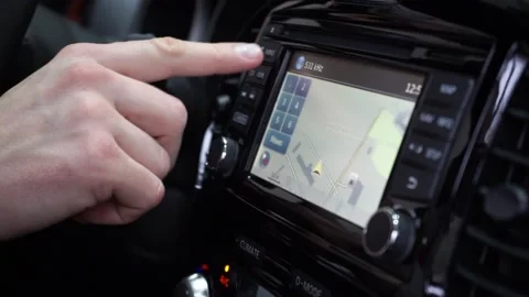 The driver adjusting the volume of a radio inside a car.  Video stock 169029701