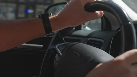 Driver adjusts hand position on steering wheel while driving car Stock Footage 346319181