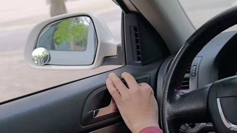 The driver adjusts the rearview mirror. Stock Footage 329166567