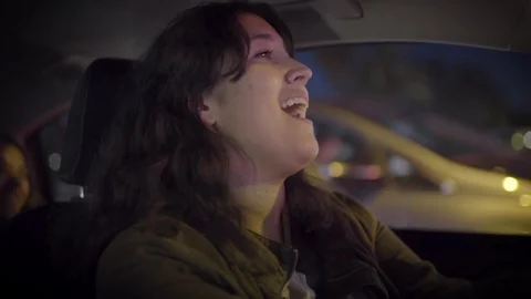 Driver And Back Seat Passenger Dance And Sing Along To Music In Car In City Stock Footage 90107996