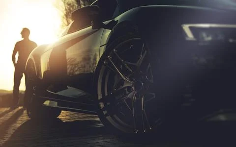 Driver and His Performance Car During Sunset Stock Photos