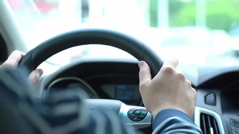 Driver behind the wheel of the car, a man keeps his hands on the steering wheel Stock Footage 157111345