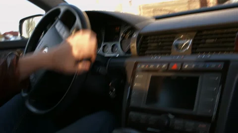 The driver behind the wheel of a car moving on a sunny day Stock Footage 50177385