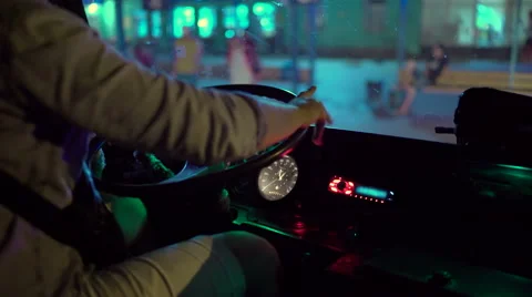 Driver behind the wheel of intercity coach leaves bus station terminal at night Video stock 66006813