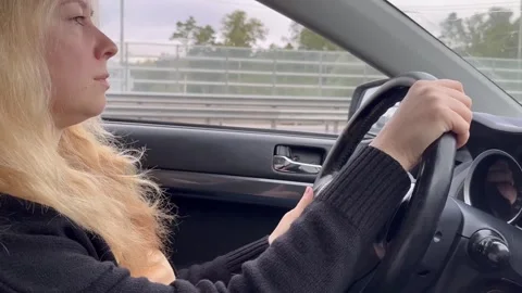 Driver behind the wheel, a view of a smiling woman in the driver's seat, th.. Stock Footage 252380142