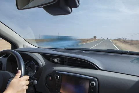 Driver being overtaken by a car in a continuous line and with a gradient chan Stock Photos