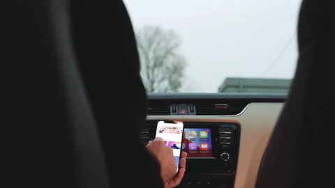Driver Browsing Apple Event on iPhone 15 Pro Stock Footage 276603413