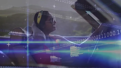 Driver brushing hair in convertible while binary code sweeping and revealing Stock Footage 317739871