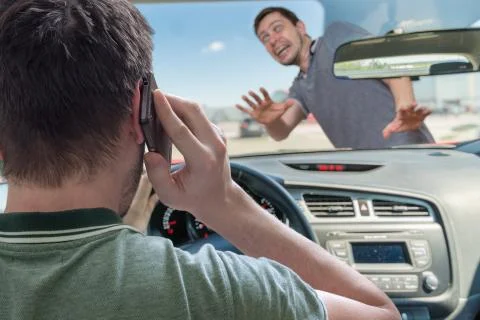 Driver calling using smartphone in car is going to hit pedestrian. Foto stock