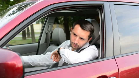 Driver of a car being bored sitting in his vehicle waiting. Stock Footage 93753816