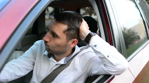 Driver of a car being bored sitting in his vehicle waiting. Stock Footage 93757903