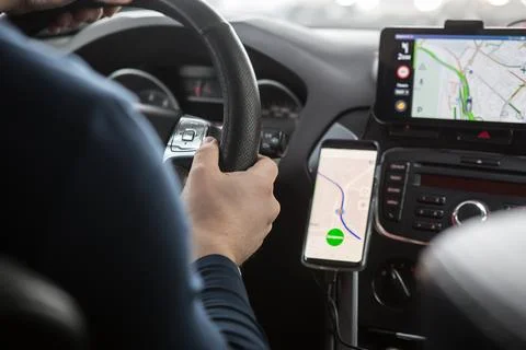 Driver in the car controls the navigator. Stock Photos