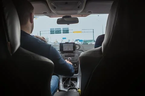 Driver in the car controls the navigator. Stock Photos