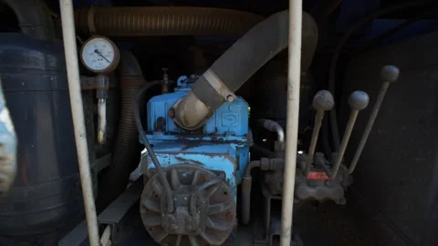 The driver of the car for sewage pumping turns on the pump with levers. Stock Footage 309294230