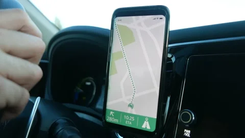 Driver of a Car Using his Smartphone with GPS Map To Navigate Stock Footage 133194674