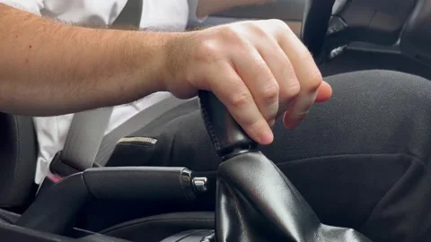 Driver changes gear on a manual transmission in a car Stock Footage 252020984