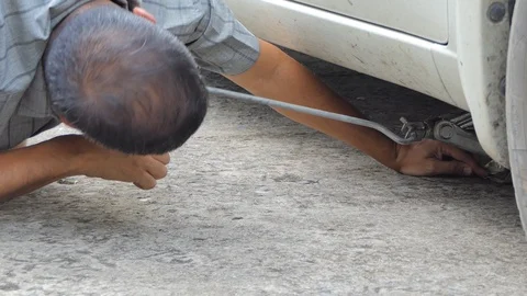 Driver changing  flat tire. Stock Footage 118023672