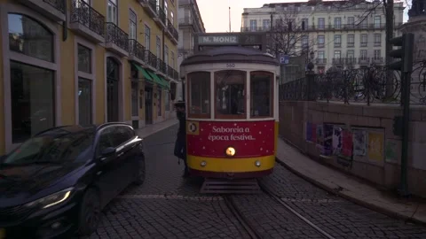 Driver changing track directon of Vintage Yellow Tram In The Center Of Lisbon Stock-Footage 186990616