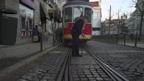 Driver changing track rail direction of Vintage Yellow Tram In The Center Of  Stock-Footage 186964144