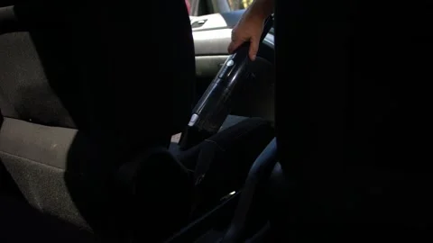 Driver cleaning car with vacuum through view of seats Stock-Footage 347220169