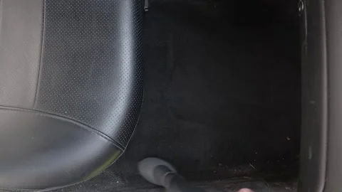 The driver cleans the car interior with a vacuum cleaner Stock Footage 229419465