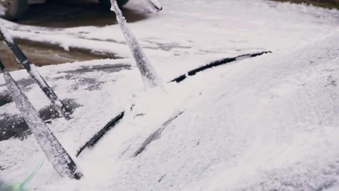 The driver clears the car from the snow close-up Stock Footage 104064505
