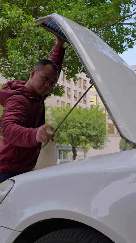 The driver closes the car hood. Stock Footage 329397689