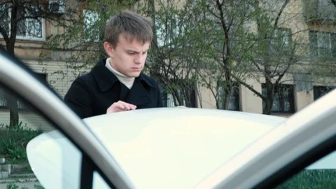 Driver closing the hood of the car. Evaluation of the technical condition Video stock 106719327